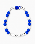 Blue and white Pawsch beaded dog necklace personalized with the name WINSTON on a white background